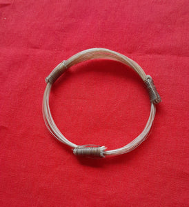 GIR15 Genuine white giraffe hair bracelet with light brown knots.