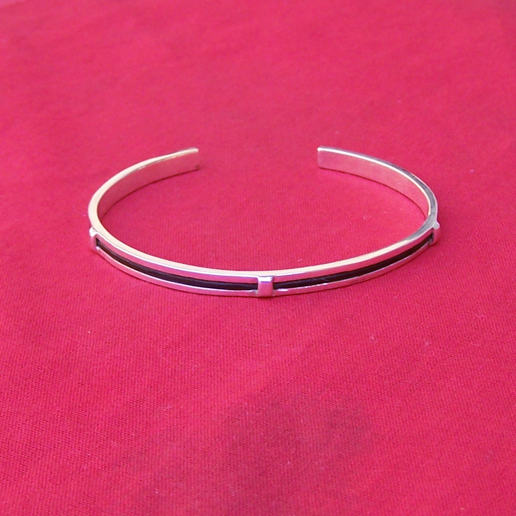 Lee's Collection #4 - A single strand of thick elephant hair encased in a solid sterling silver band.