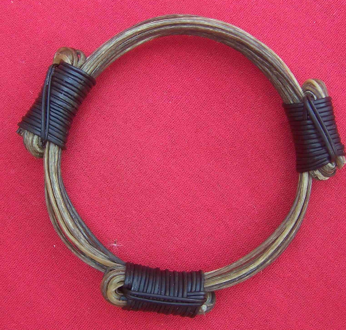 Traditionally styled collector's edition with 12 of the finest quality brown elephant hairs fastened together with 3 black elephant hair knots. 3.5"/8.89cm in diameter, better suited to a medium to large wrist or as a bangle for a medium wrist. - BB7